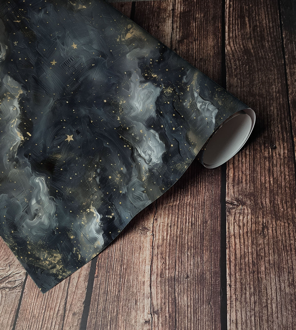 Dark celestial wallpaper with painterly charcoal and grey clouds, scattered gold stars and subtle metallic-style speckles up close