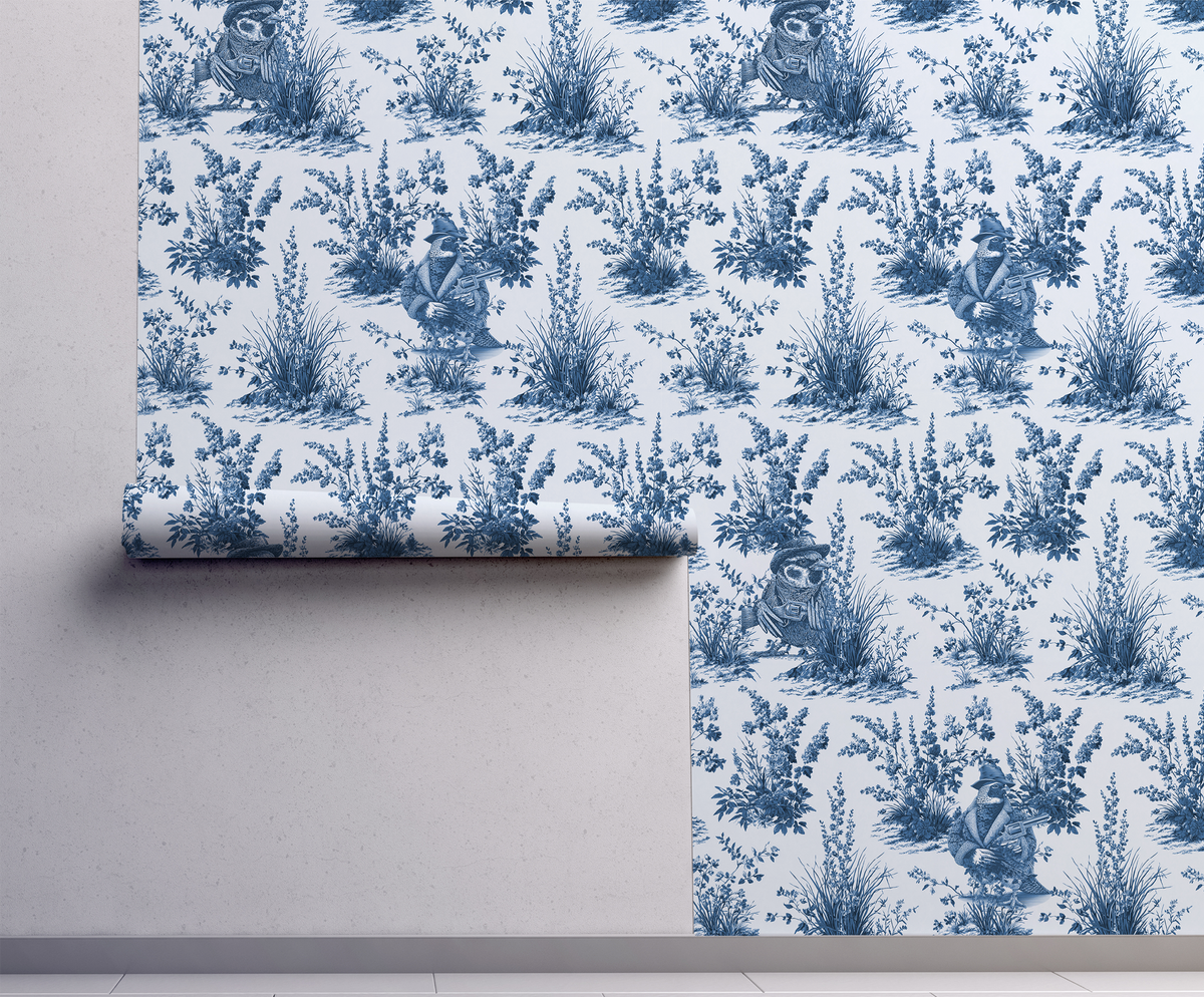 Blue and white toile peel and stick wallpaper roll featuring vintage western wildlife birds and botanical illustrations, classic toile de jouy repeat pattern in blue ink on white background, on wall, removable wallpaper Canada