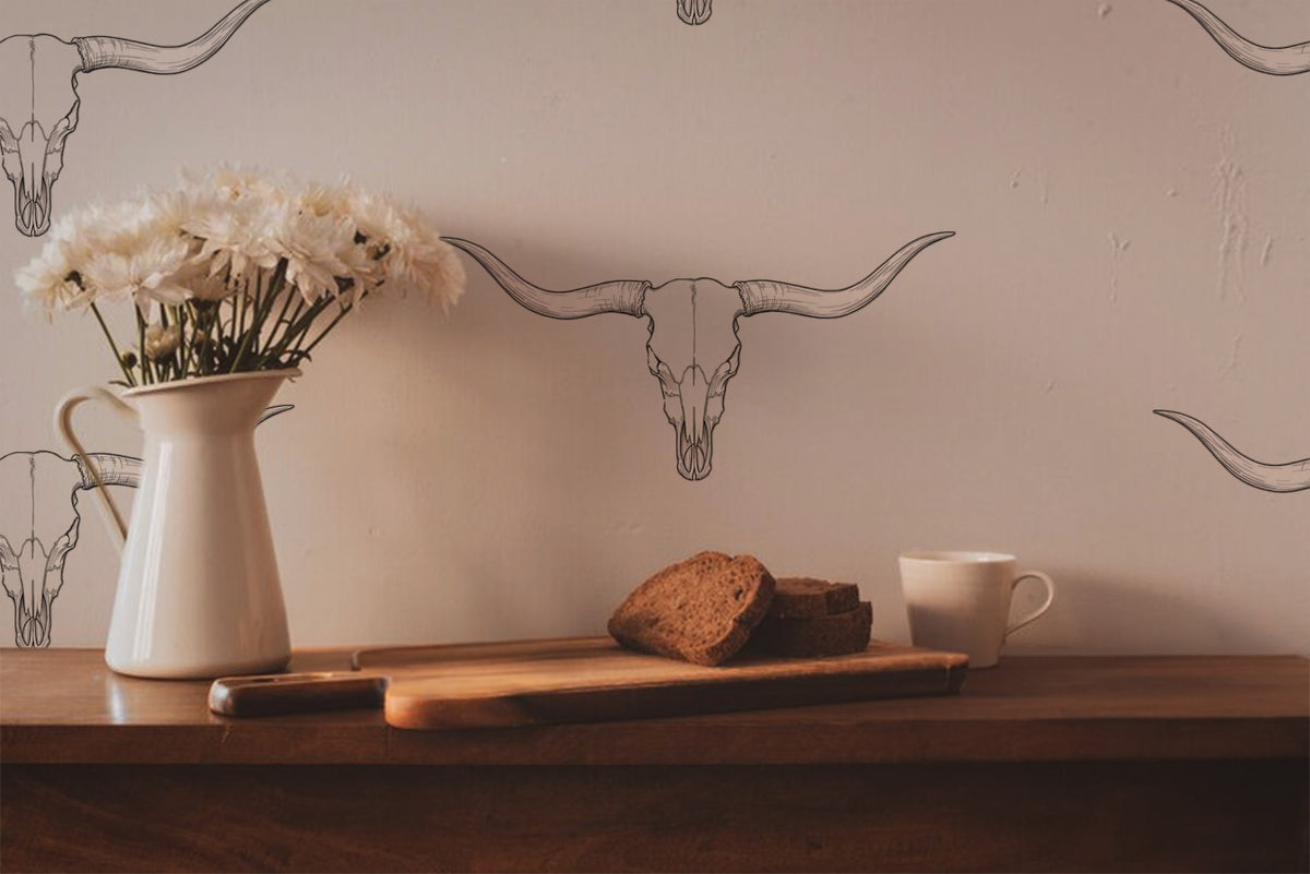Western longhorn wallpaper featuring minimalist hand-drawn cattle skulls on a warm cream background, creating a modern ranch, western farmhouse, and rustic cowboy aesthetic for entryways, bedrooms, and living spaces, in kitchen
