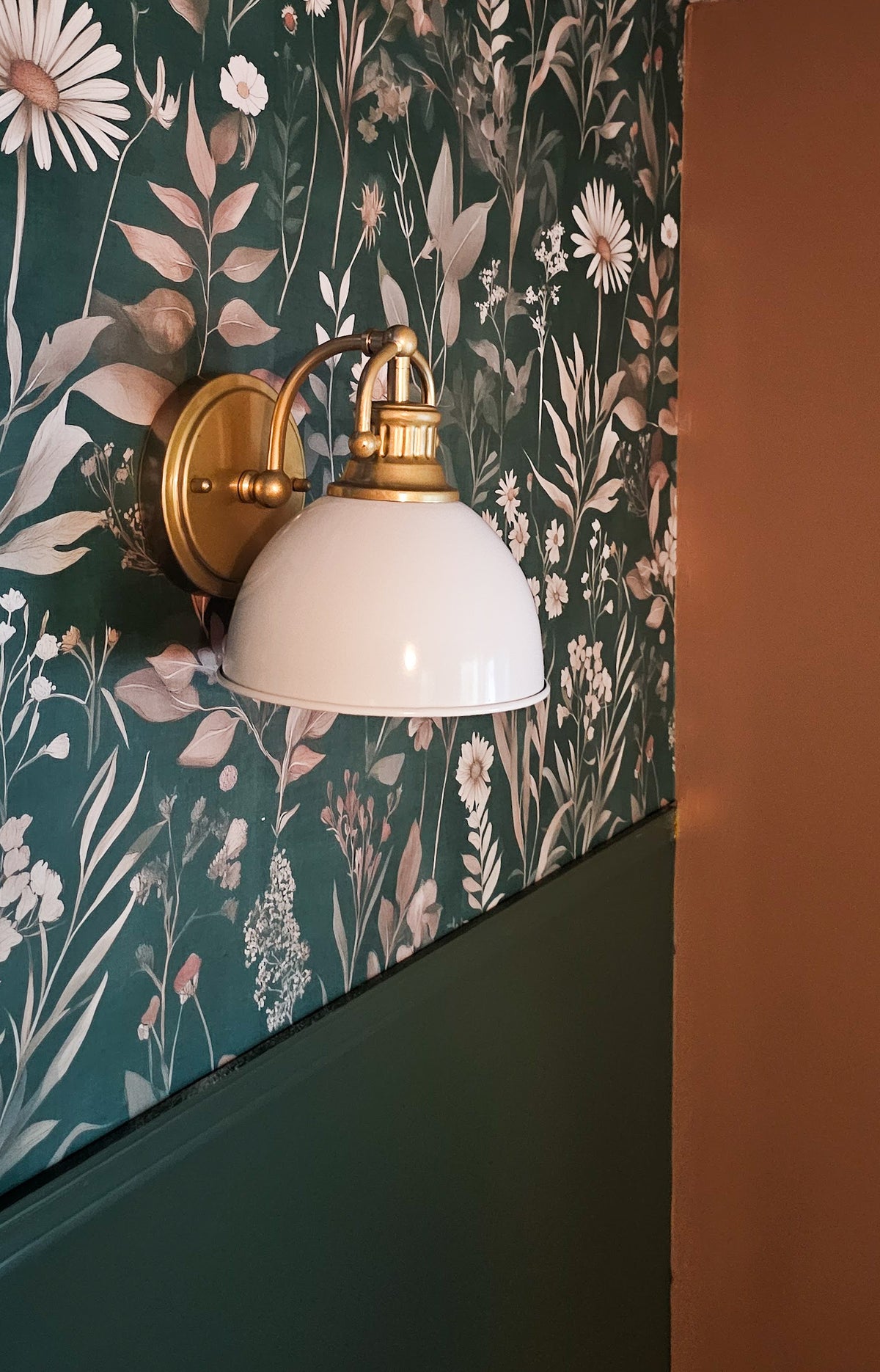 Dark moody wallpaper with dramatic oversized floral blooms in deep navy, charcoal, and inky black tones with rich botanical detail on wall