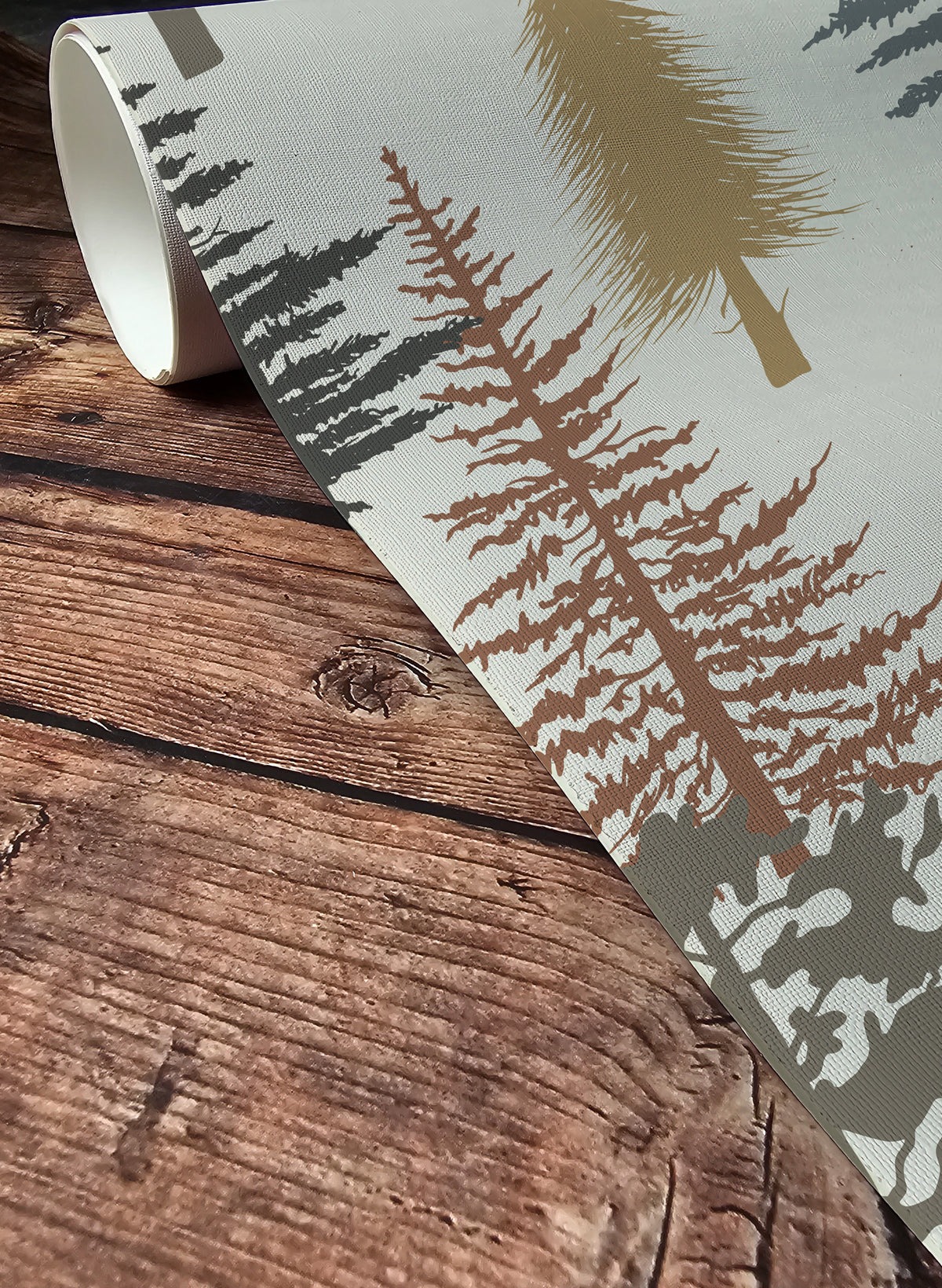 Forest tree wallpaper featuring stylized pine and evergreen trees in sage green, charcoal, taupe, mustard, and rust tones on a warm neutral background, inspired by woodland and cabin décor up close