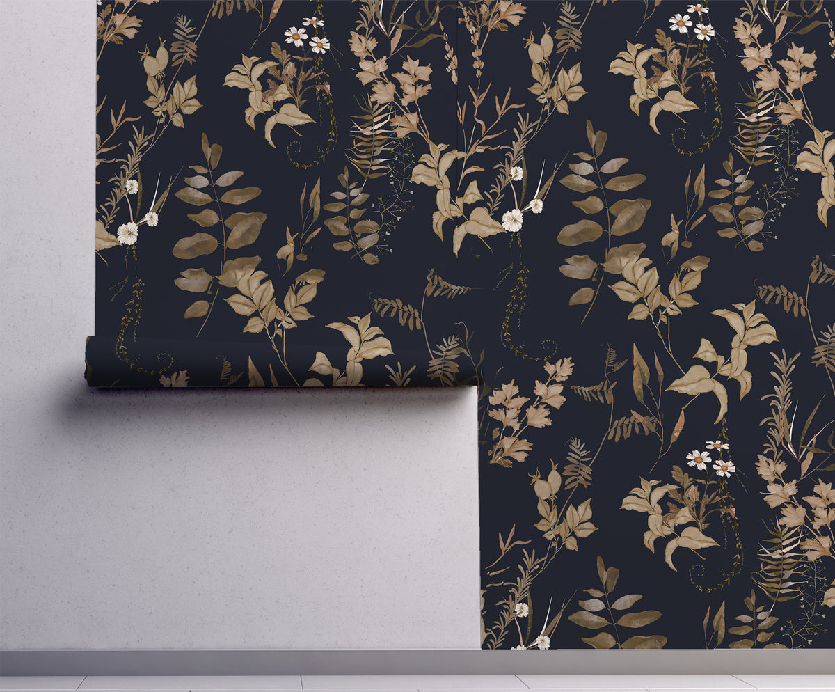 Dark floral wallpaper with vintage botanical leaves, delicate white wildflowers and warm brown foliage on a deep navy blue background on wall.