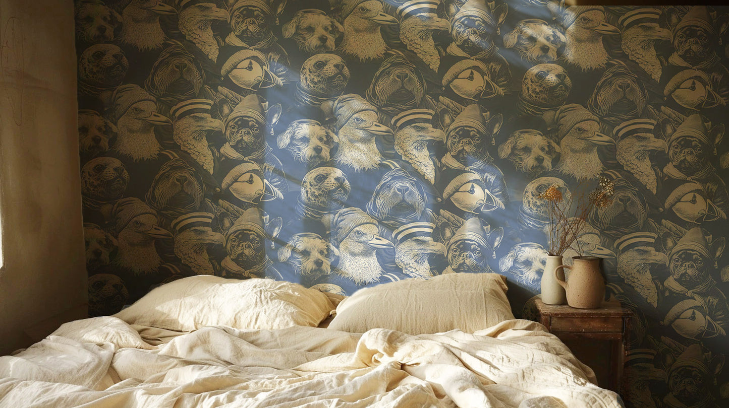 Blue peel-and-stick wallpaper sample featuring detailed illustrated animal portraits, including puffins, eagles, pugs, ducks, and sea otters wearing knit hats and sailor caps in a whimsical nautical style in bedroom