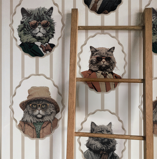 Whimsical peel-and-stick wallpaper featuring vintage-style cat portraits in scalloped frames on a soft beige striped background displayed