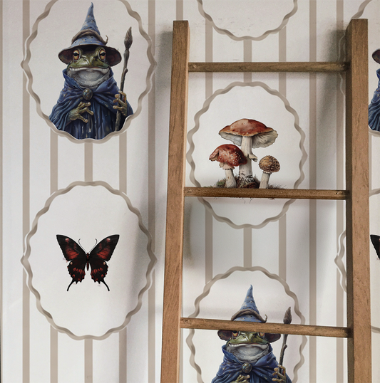 Whimsical peel -and-stick wallpaper featuring framed toad wizard portraits, mushrooms, and butterflies on a soft beige striped background on display