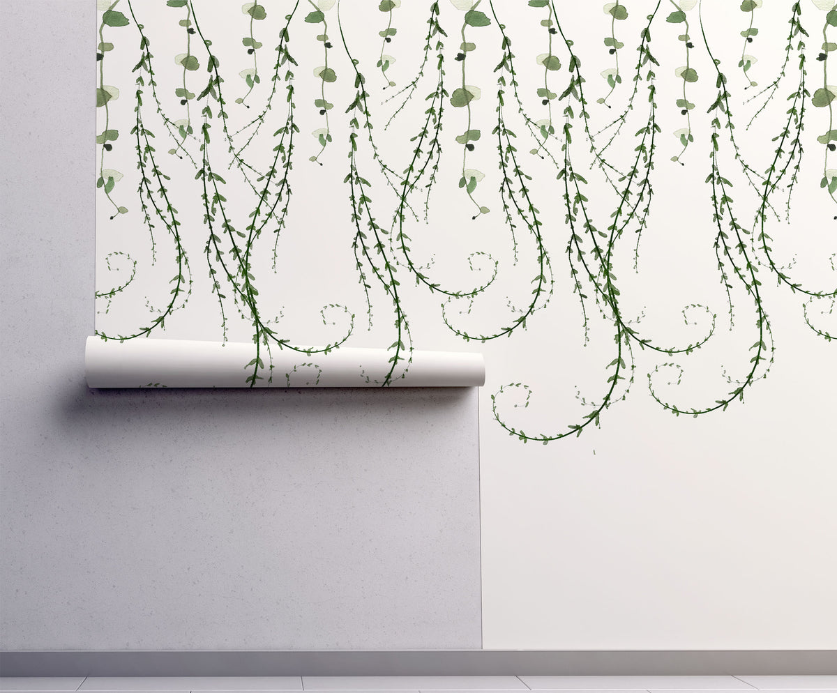 Trailing vines wallpaper with delicate cascading greenery on a warm cream background. A whimsical botanical design for cottagecore and nature-inspired interiors.
