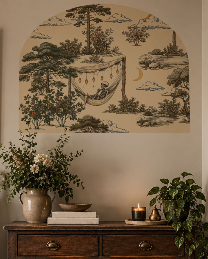 Skeleton relaxing in a hammock wall arch decal, whimsical removable wall decor with dark humor for offices, bedrooms and reading nooks, located in office.