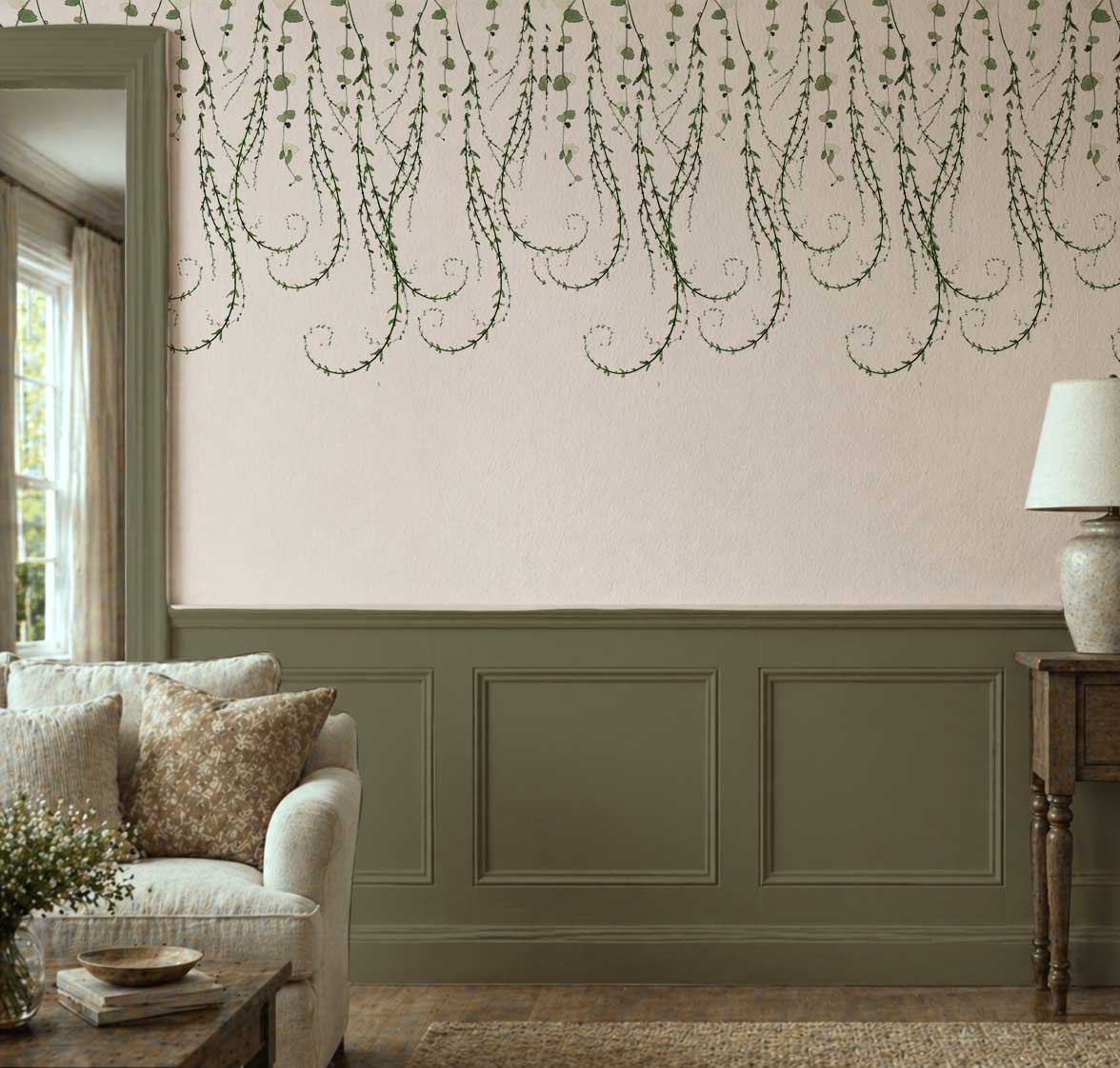 Trailing Vines botanical peel and stick wallpaper with cascading green vines on a cream wall in a cottage-style living room