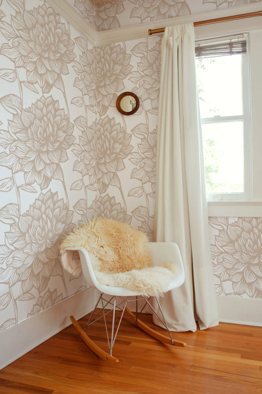 Beige and cream botanical wallpaper with oversized hand-drawn leaves and floral foliage in a soft neutral colour palette in nursery.