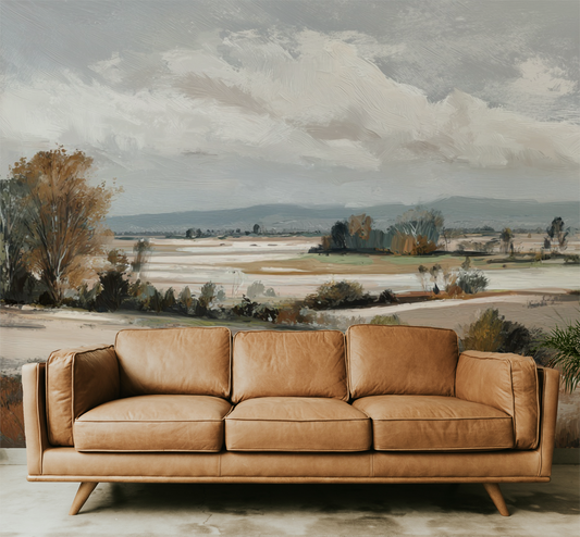 Brown leather sofa in front of a landscape wall mural