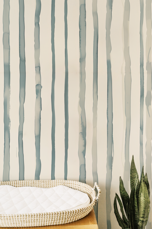 Soft watercolor stripe wallpaper with vertical blue green stripes on a warm neutral background in room