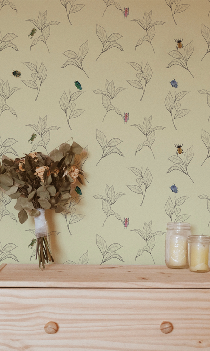 Vintage beetle wallpaper featuring colorful illustrated beetles scattered among delicate hand-drawn botanical leaves on a warm cream background, peel and stick wallpaper for cottagecore and nature-inspired interiors.