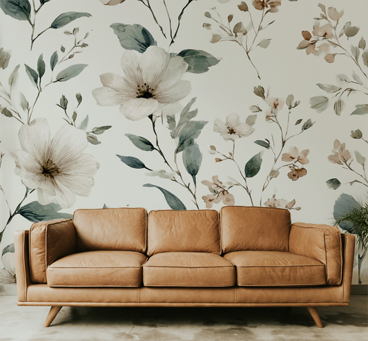 Soft neutral wildflower wall mural with delicate botanical flowers in beige and sage tones and sofa