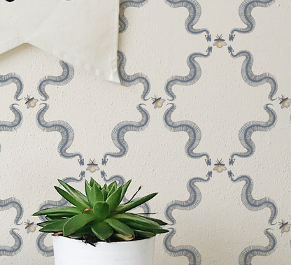 Snake skeleton wallpaper with repeating skeletal serpents and small bees, vintage peel and stick wallpaper pattern on wall
