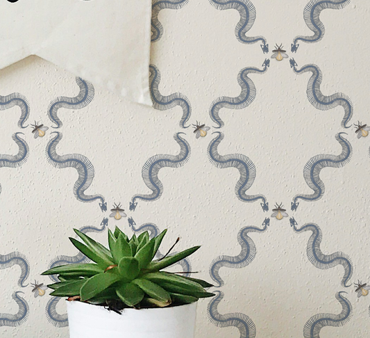 Snake skeleton wallpaper with repeating skeletal serpents and small bees, vintage peel and stick wallpaper pattern on wall