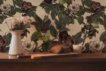 Luna Moth wallpaper with pale green mot hs, dusty mauve and cream roses, and deep green foliage on a warm ivory background