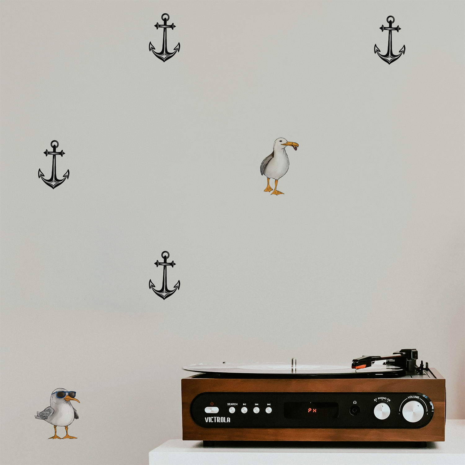 Whimsical nautical wallpaper with scattered anchors and quirky seagull illustration, minimalist peel and stick wallpaper on wall