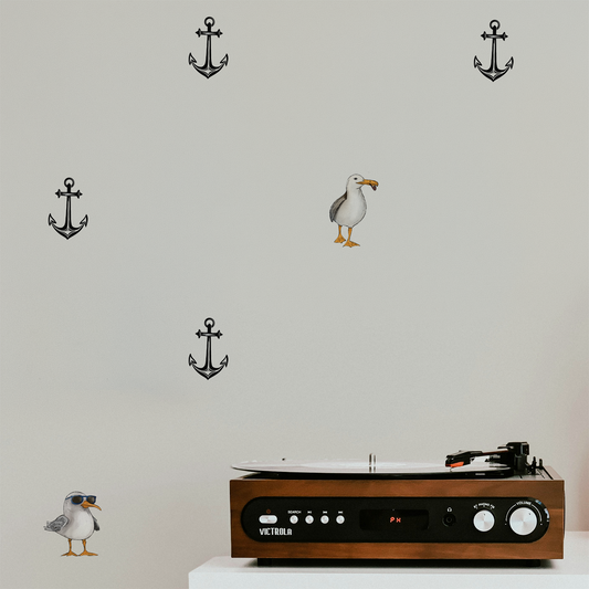 Whimsical nautical wallpaper with scattered anchors and quirky seagull illustration, minimalist peel and stick wallpaper on wall