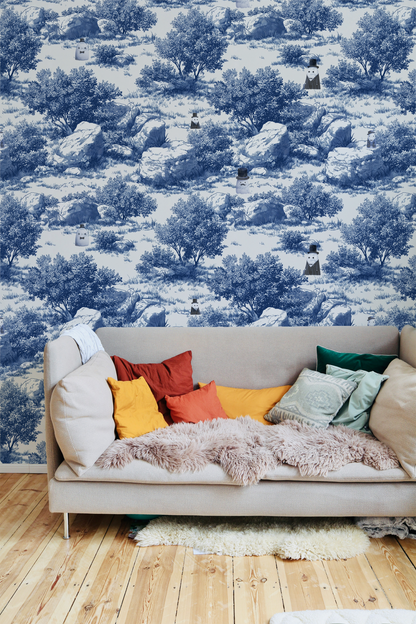 Blue toile peel and stick wallpaper with pastoral landscape, rocks and trees, whimsical ghost characters in vintage top hats in living room