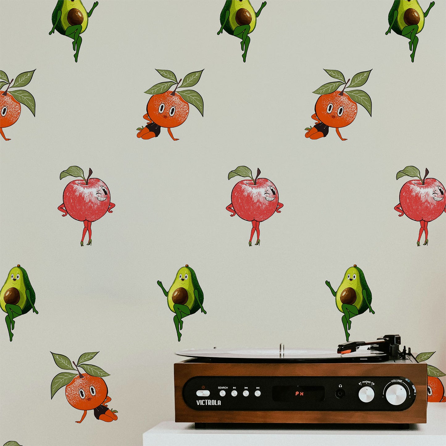Retro fruit wallpaper with quirky pin up style oranges apples and avocados on a neutral background in a playful kitchen interior style