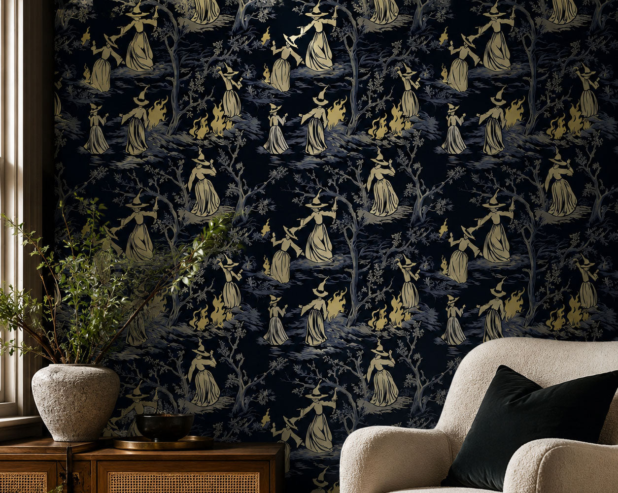 Dark witch toile wallpaper featuring vintage witches, woodland trees, and bonfire scenes on a deep navy background, creating a gothic cottagecore aesthetic for moody bedrooms, reading nooks, and dark academia interiors, in living room