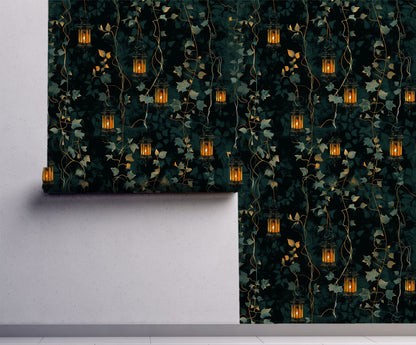 Dark cottagecore wallpaper featuring glowing vintage lanterns hanging among trailing ivy vines and lush botanical foliage.