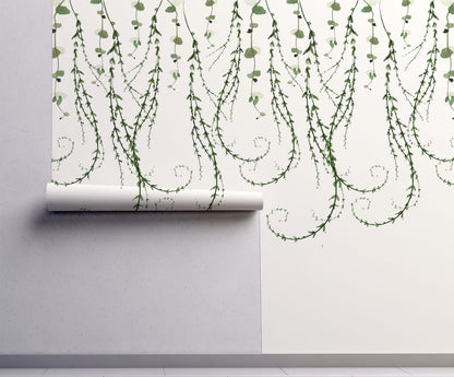 Trailing vines wallpaper with delicate cascading greenery on a warm cream background. A whimsical botanical design for cottagecore and nature-inspired interiors.