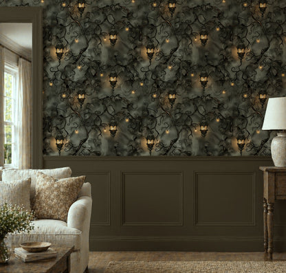 Dark botanical wallpaper with twisting ivy vines, glowing vintage lanterns and warm golden lights on a moody charcoal green background in living room.