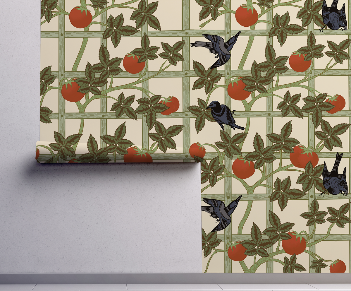 Vintage botanical wallpaper featuring black birds, red tomatoes and climbing green vines on a cream garden trellis on wall.