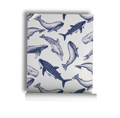 Coastal whale wallpaper with navy blue vintage style whale illustrations on a soft neutral background in a nautical cottage style interior