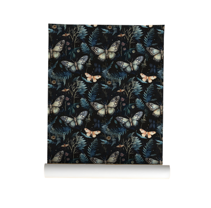 Roll of wallpaper with moth and leaf pattern on a dark background