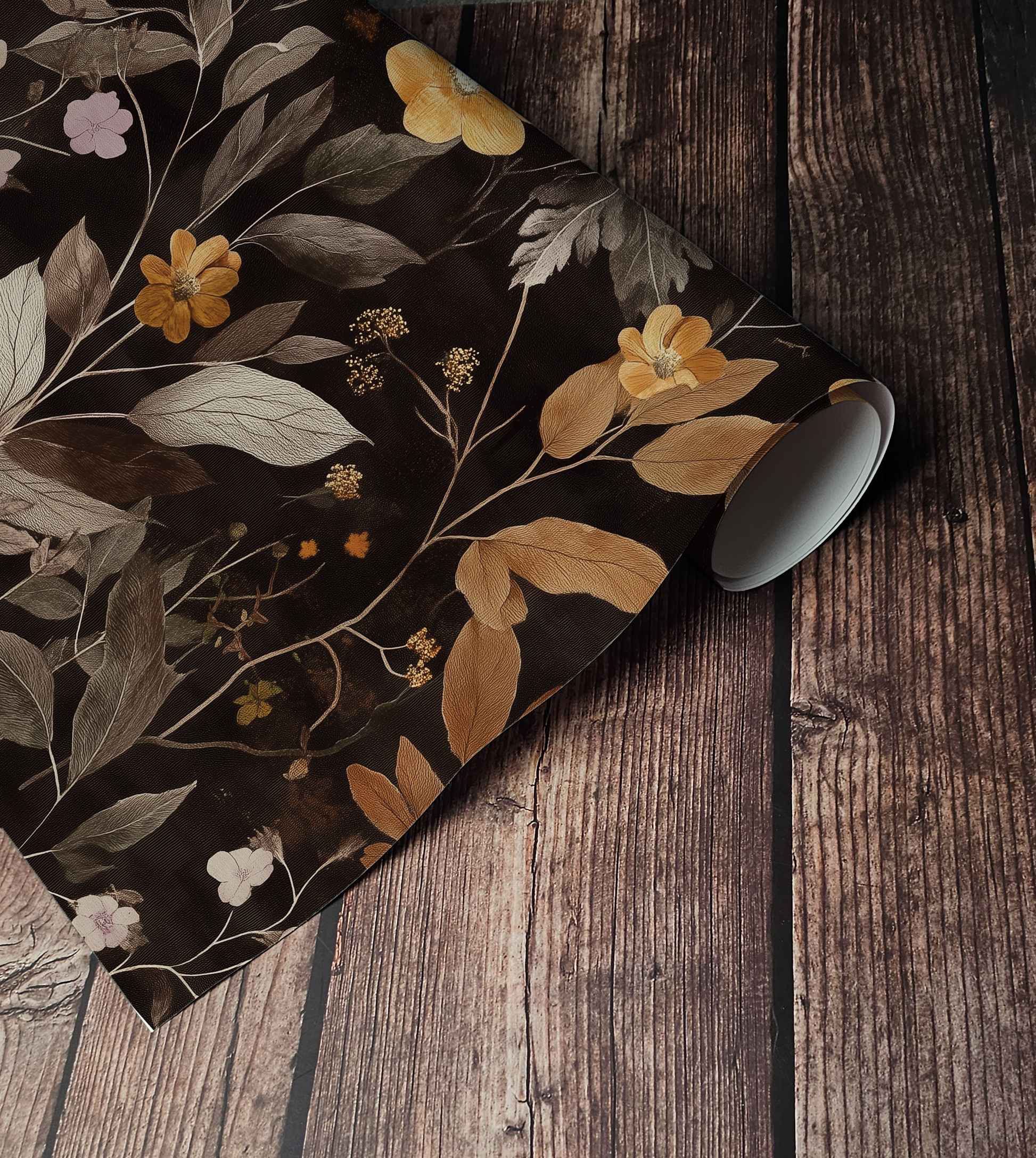 Dark botanical wallpaper featuring golden wildflowers, taupe foliage, and delicate floral stems on a black background, creating a moody cottagecore and dark academia aesthetic.