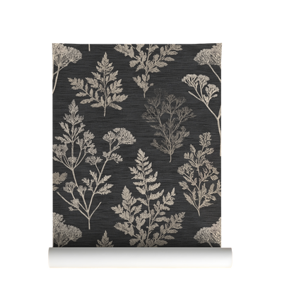 Roll of wallpaper with a neutral botanical pattern on a dark background