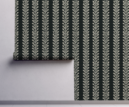 Dark botanical vine wallpaper with repeating cream leaf vines on a deep green background On wall