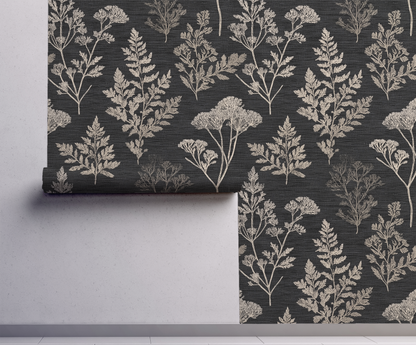 Roll of wallpaper with a floral pattern on a dark background