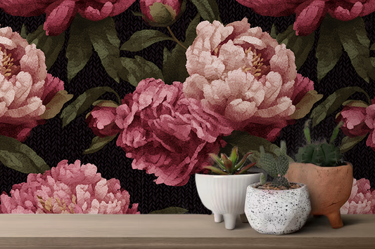 Decorative wallpaper with pink flowers and green leaves on a black background, with small potted plants in the foreground.