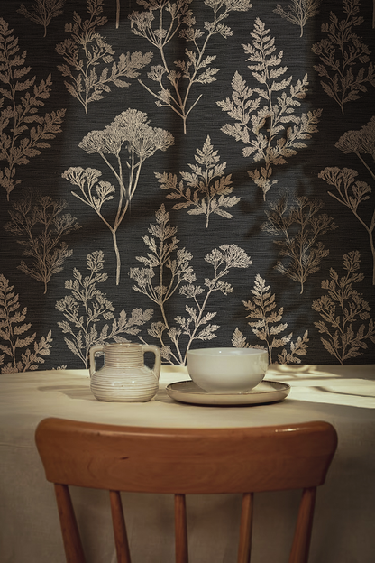 Dining table with ceramic cup and saucer against a dark botanical floral wallpaper.