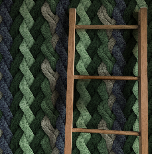 Evergreen cable knit wallpaper with braided knit pattern in layered green tones On wall