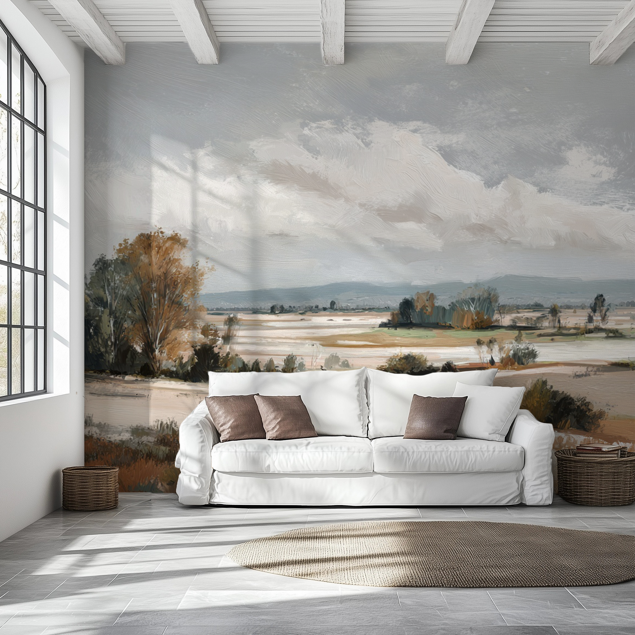 White sofa with brown cushions in a room with a large wall mural of a landscape.