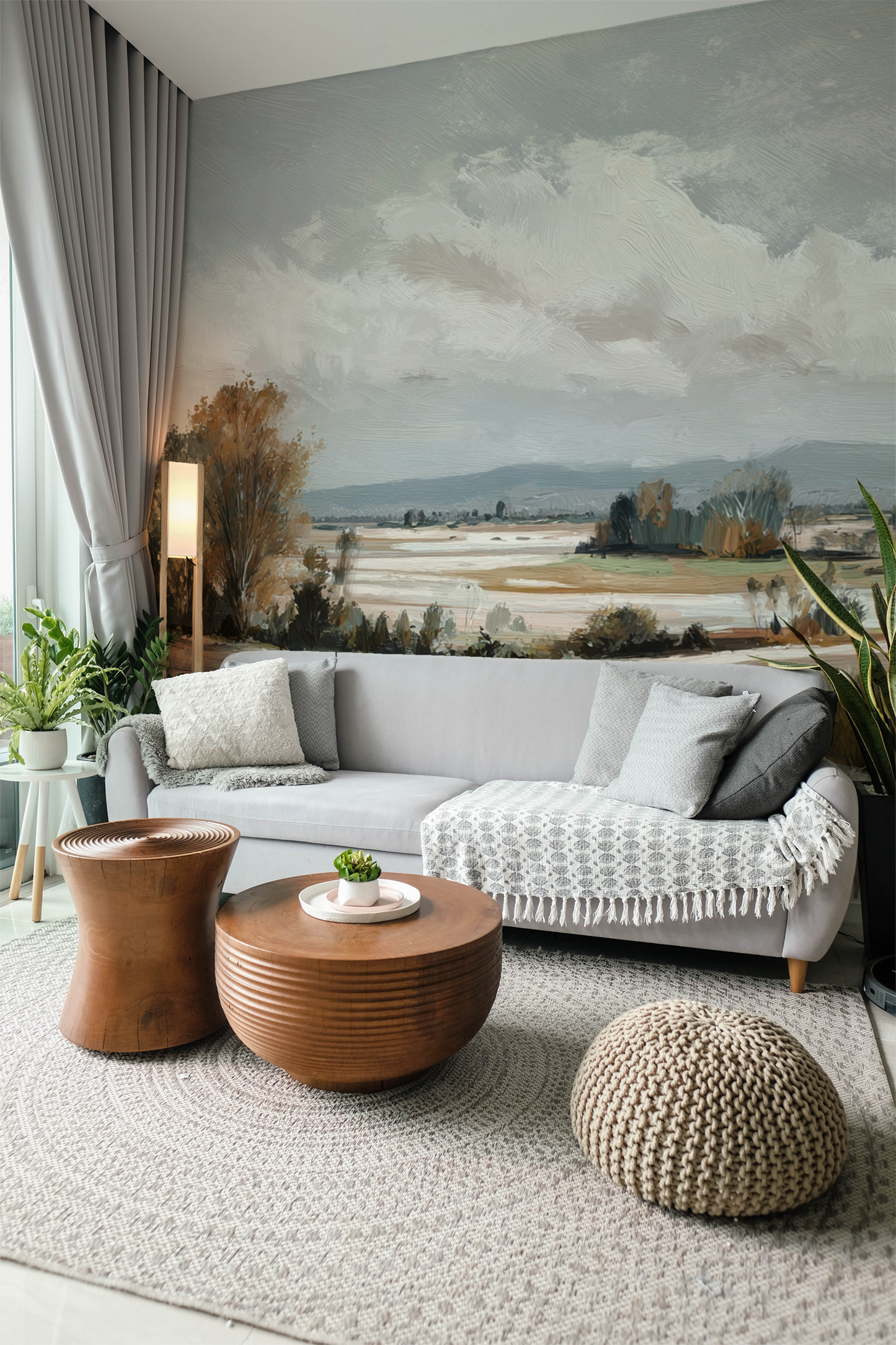 Modern living room with a gray sofa, wooden coffee table,  landscape wall mural.