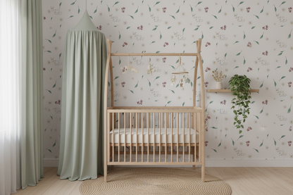 Neutral nursery wallpaper featuring delicate wildflowers, leafy botanicals, and the phrase "Be Wild Child" on a soft cream background, creating a whimsical cottagecore nursery space.
