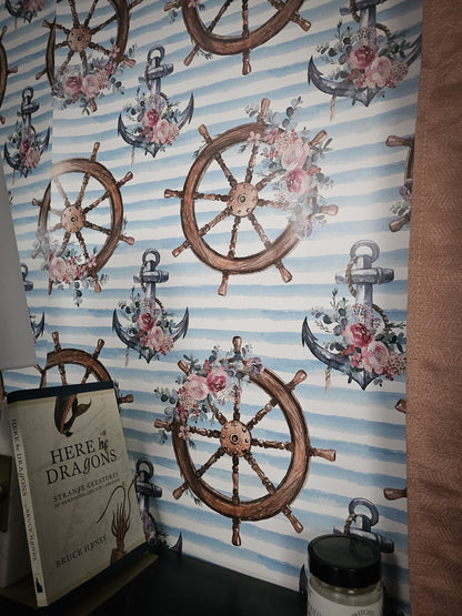 Wallpaper with nautical designs including ship wheels, anchors, and flowers on a striped background.