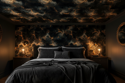 Dark celestial cloud wallpaper in black, charcoal and warm gold tones, shown on a dramatic bedroom feature wall.